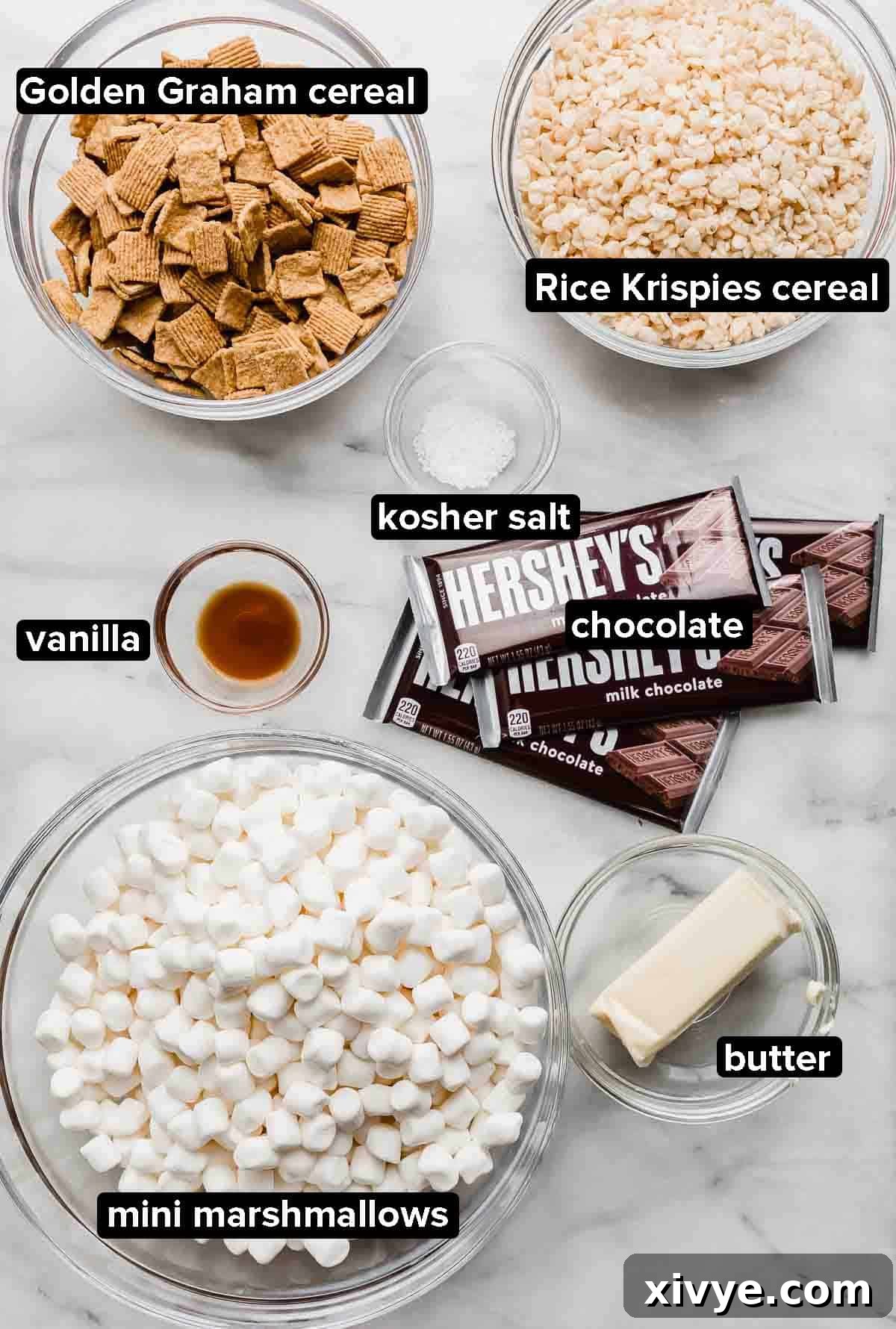 S'more Rice Krispie Treats ingredients on a gray and white marble background. 