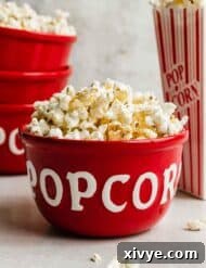 Sweet and Salty Kettle Corn 7 Kettle Corn Popcorn in a red bowl against a gray background.