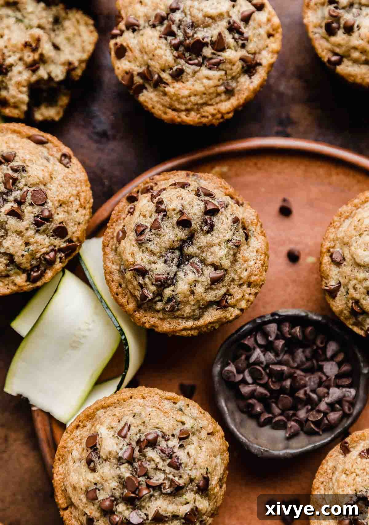 Garden Delight Chocolate Chip Muffins 2 Zucchini Chocolate Chip Muffins on a brown plate.