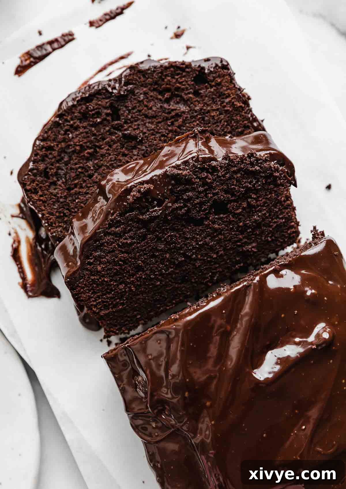 Overhead photo of a Chocolate Pound Cake cut into slices, showcasing its rich texture and glossy ganache.