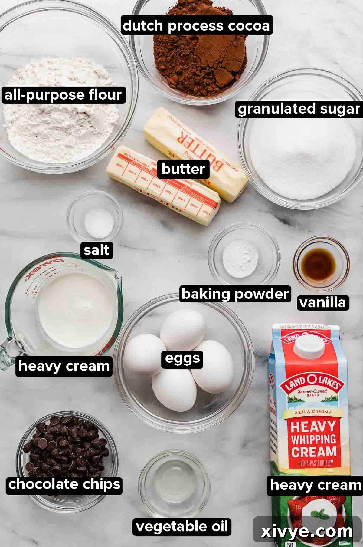 Chocolate Pound Cake with a glaze ingredients arranged on a white marble background.