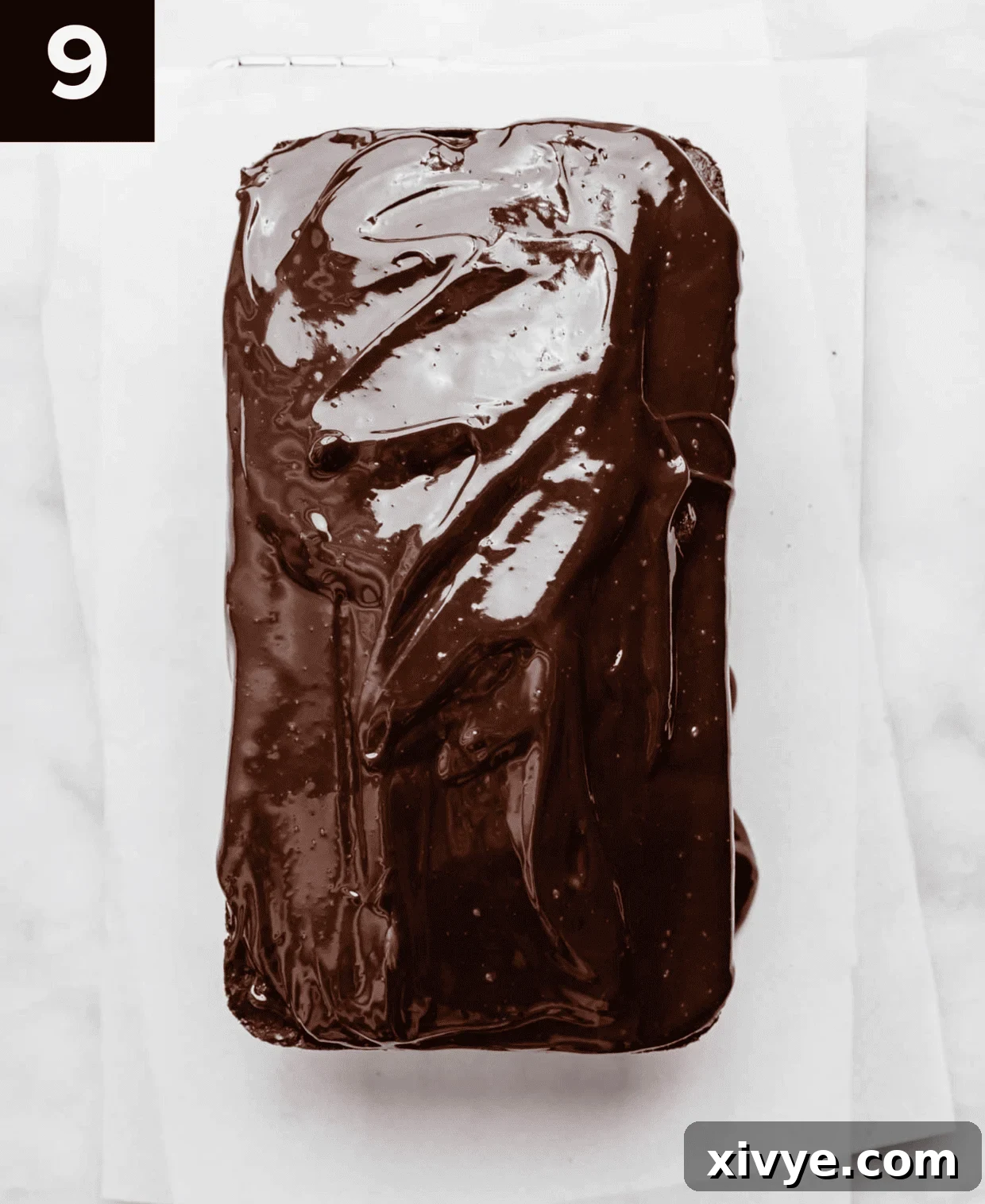 Overhead photo of a chocolate glazed Chocolate Pound Cake on a white background.