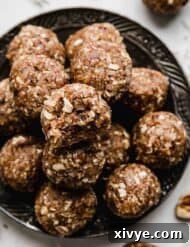 German Chocolate Cake Protein Balls on a black plate.
