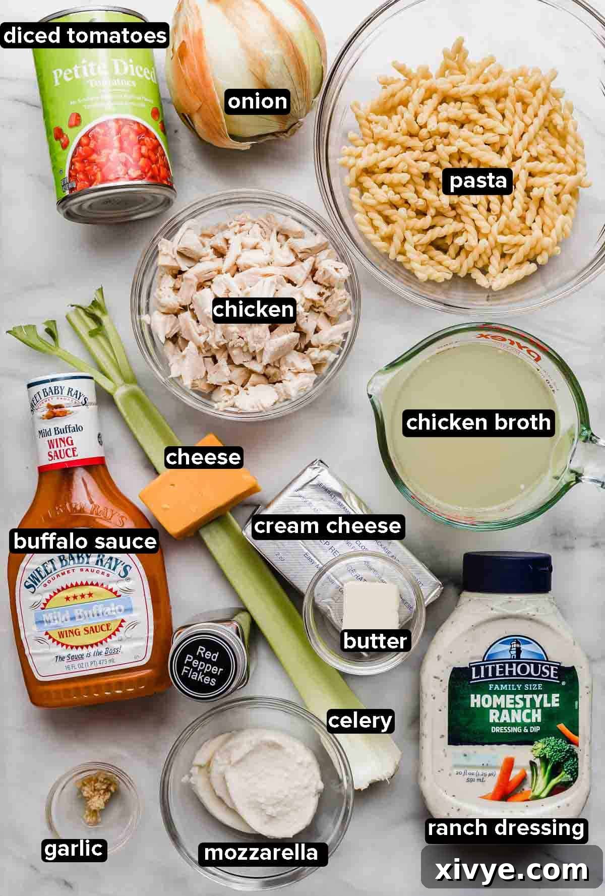 Buffalo Chicken Pasta ingredients portioned into glass bowls on a white background.