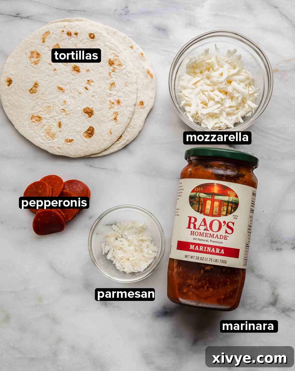 Tortilla Pizza ingredients on a white marble background: tortillas, pepperoni, mozzarella, parmesan, and marinara sauce.