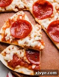 A triangle slice of pepperoni topped Tortilla Pizza.