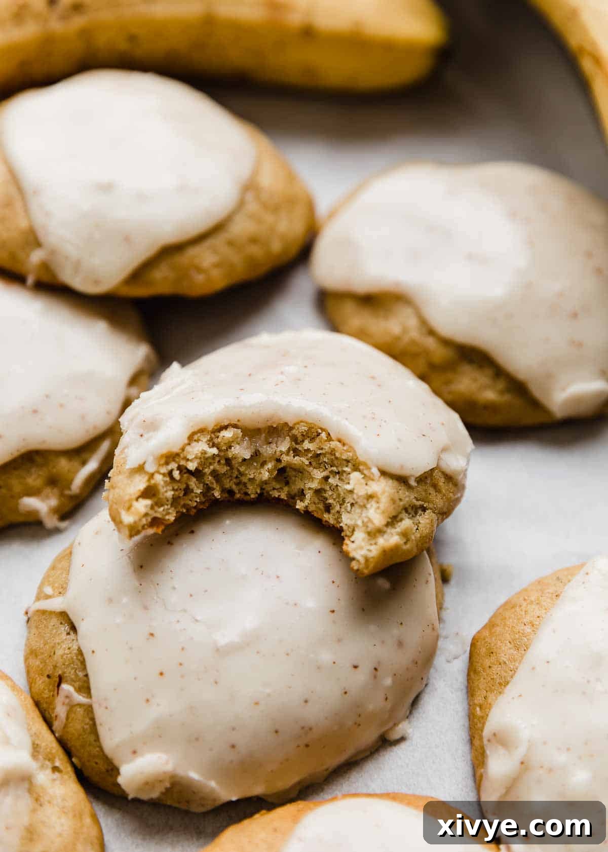 Frosted Banana Cookies with one cookie having a bite taken out of it.