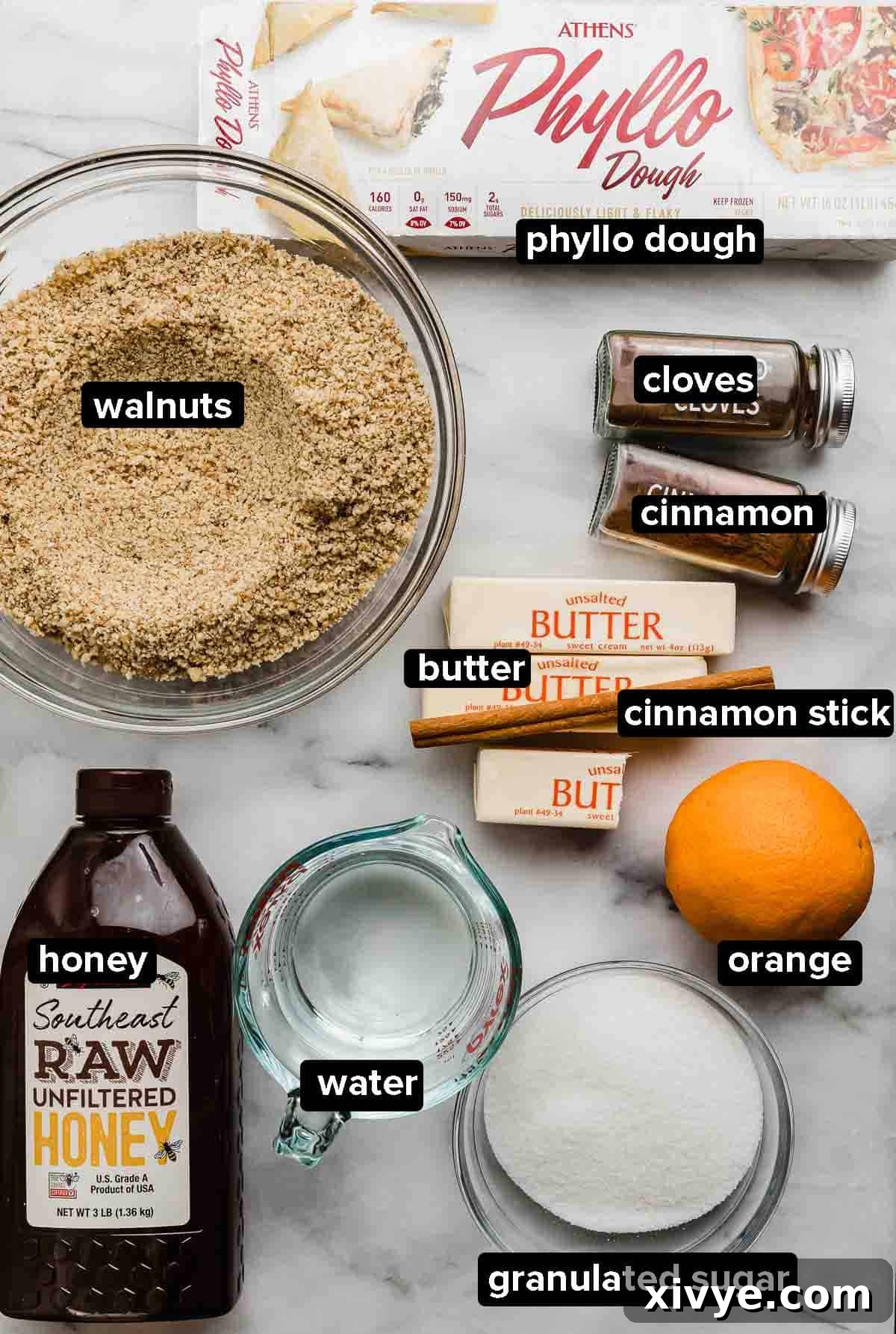 Honeyed Layers of Greece 3 Greek Baklava ingredients on a white marble background: ground walnuts, cinnamon, cloves, honey, water, orange, phyllo dough, sugar, and butter, neatly arranged.