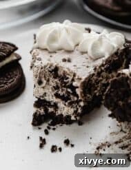 Slice of Oreo pie, Cookies and Cream Pie, with a bite taken out of the pie.