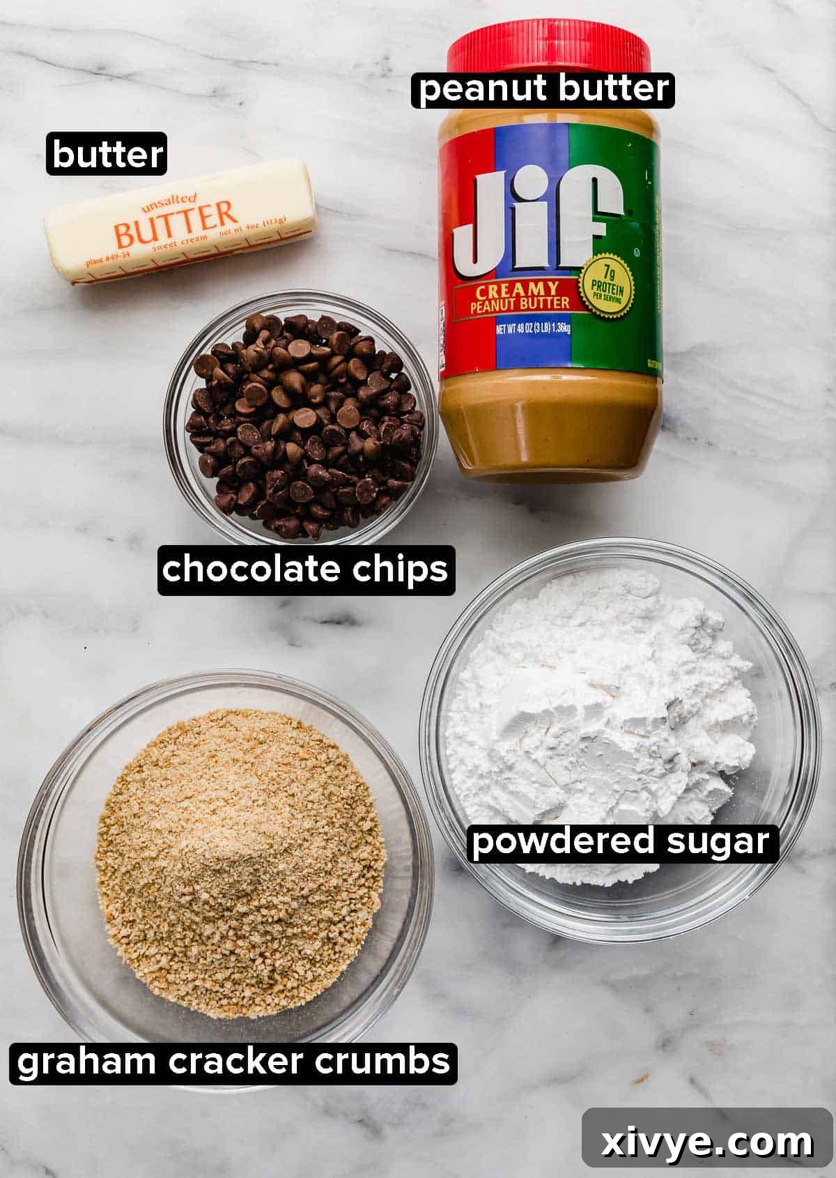 Irresistible Chocolate Peanut Butter Bliss 3 All the ingredients for Chocolate Peanut Butter Bars laid out on a white marble background: creamy peanut butter, softened butter, chocolate chips, graham cracker crumbs, and powdered sugar.