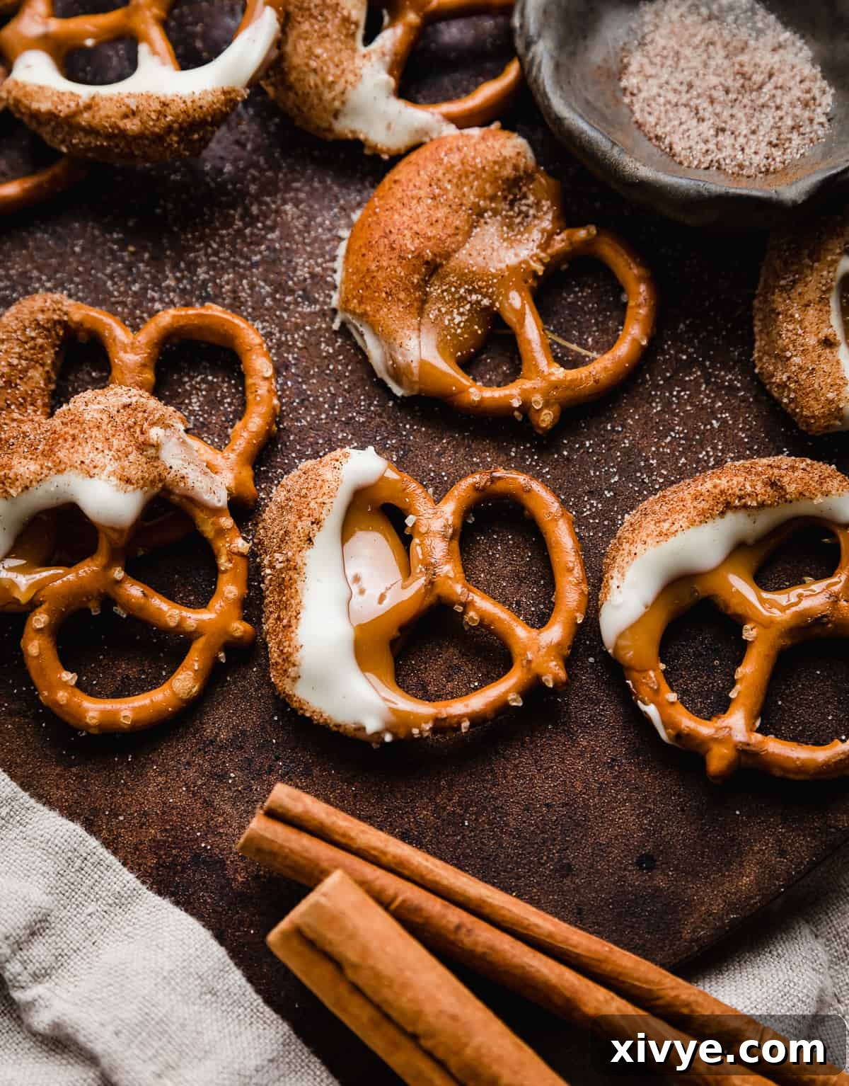 Caramel White Chocolate Cinnamon Dipped Pretzels on a brown background, showcasing their delicious layers.