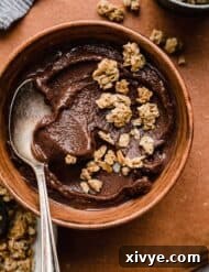 Decadent Chocolate Acai Bliss 6 Chocolate Acai smoothie in a brown bowl topped with granola.