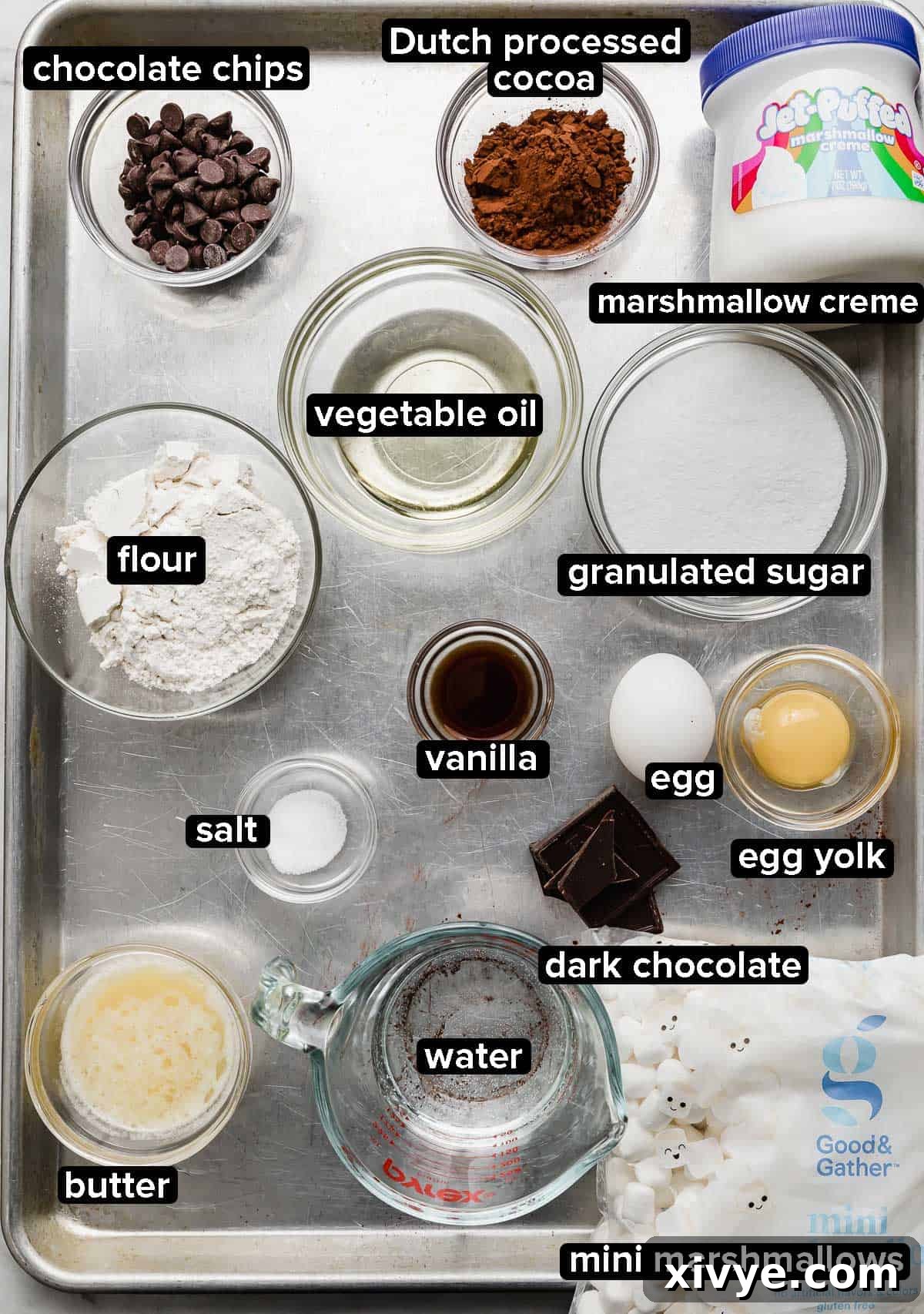 Marshmallow Brownies ingredients on a baking sheet, each portioned into glass bowls. 