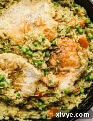 Caribbean Curried Chicken with Coconut Rice and Beans 12 A black skillet with one pan skillet Curry Chicken and rice recipe in it.