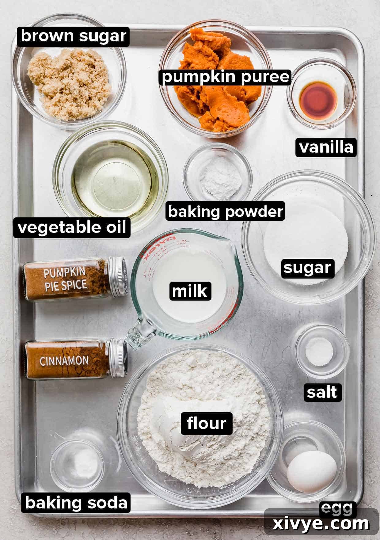 Golden Pumpkin Pecan Crumble Coffee Cake 3 All the dry and wet ingredients for the pumpkin coffee cake, meticulously portioned into glass bowls on a silver baking sheet, ready for mixing.