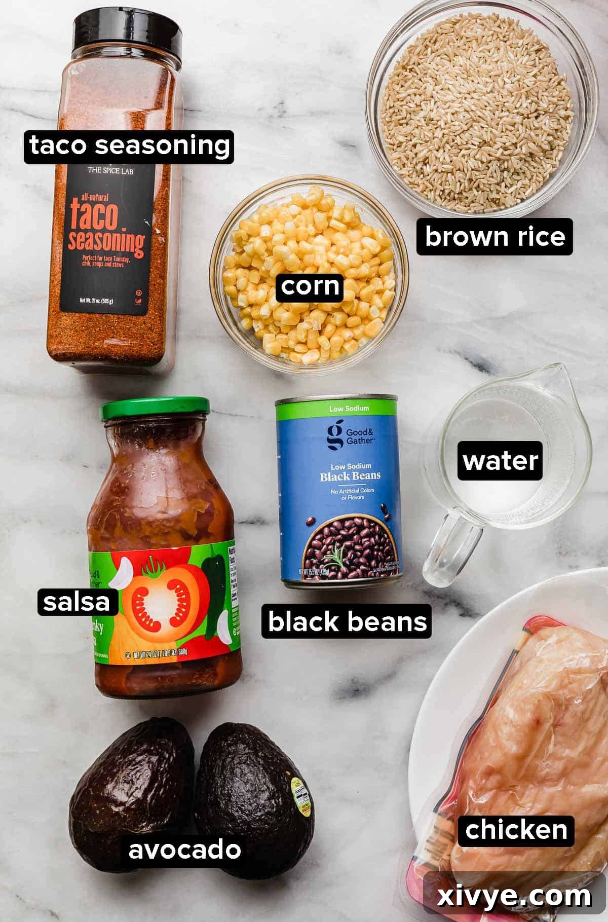 Instant Pot Chicken Taco Bowls ingredients on a white background: black beans, salsa, taco seasoning, chicken, water, corn, and brown rice, arranged neatly before cooking.