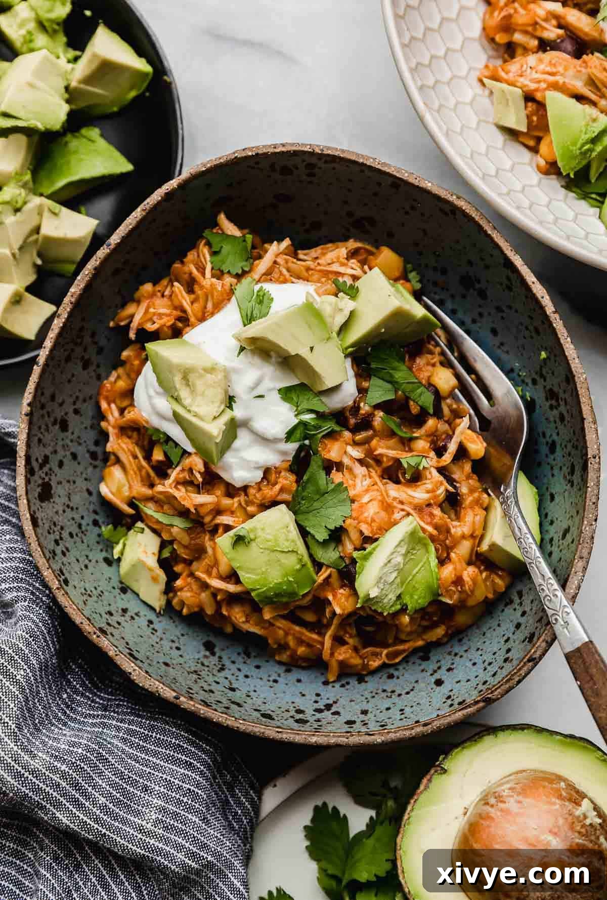A blue bowl filled with shredded chicken taco bowls made in the instant pot, ready to be enjoyed.