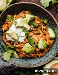 A blue bowl filled with the best chicken taco bowls with brown rice, made in the instant pot.