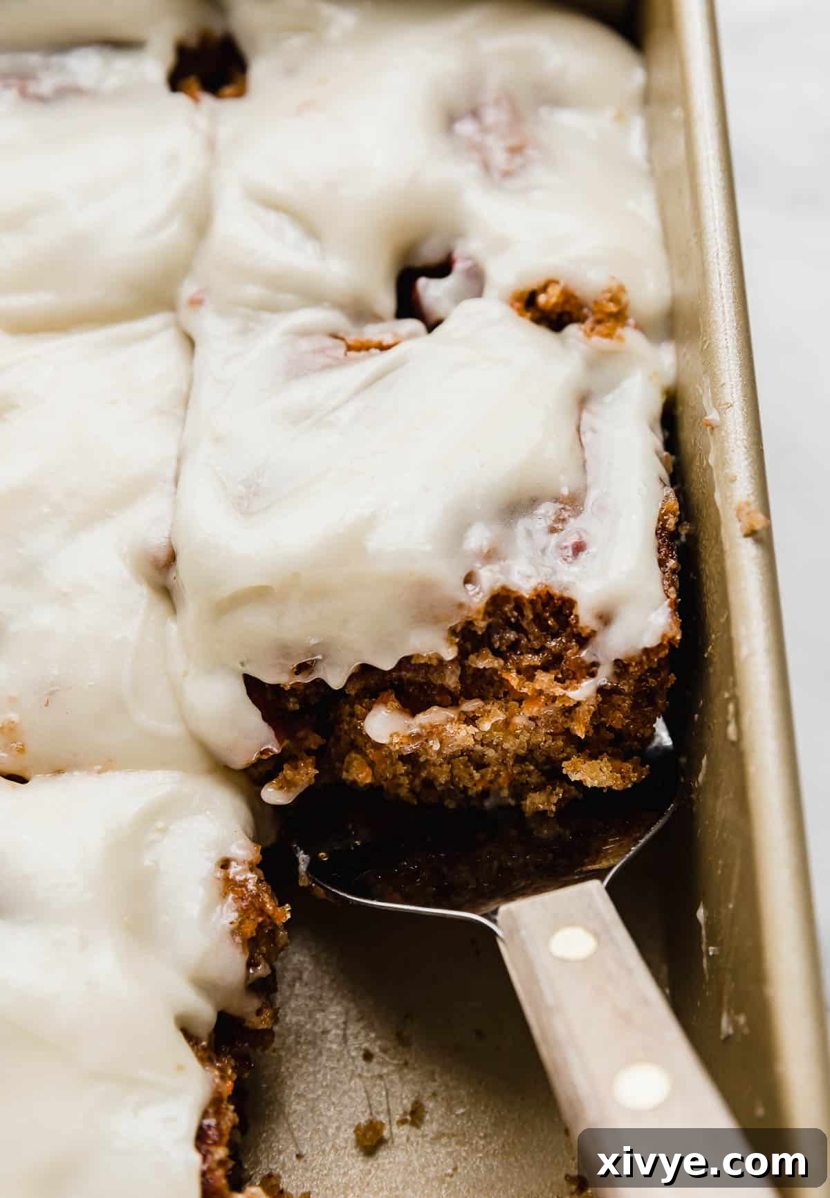 Spiced Carrot Crumb Cake 8 The best Carrot Coffee Cake cut into squares with a metal spatula scooping up one of the slices.