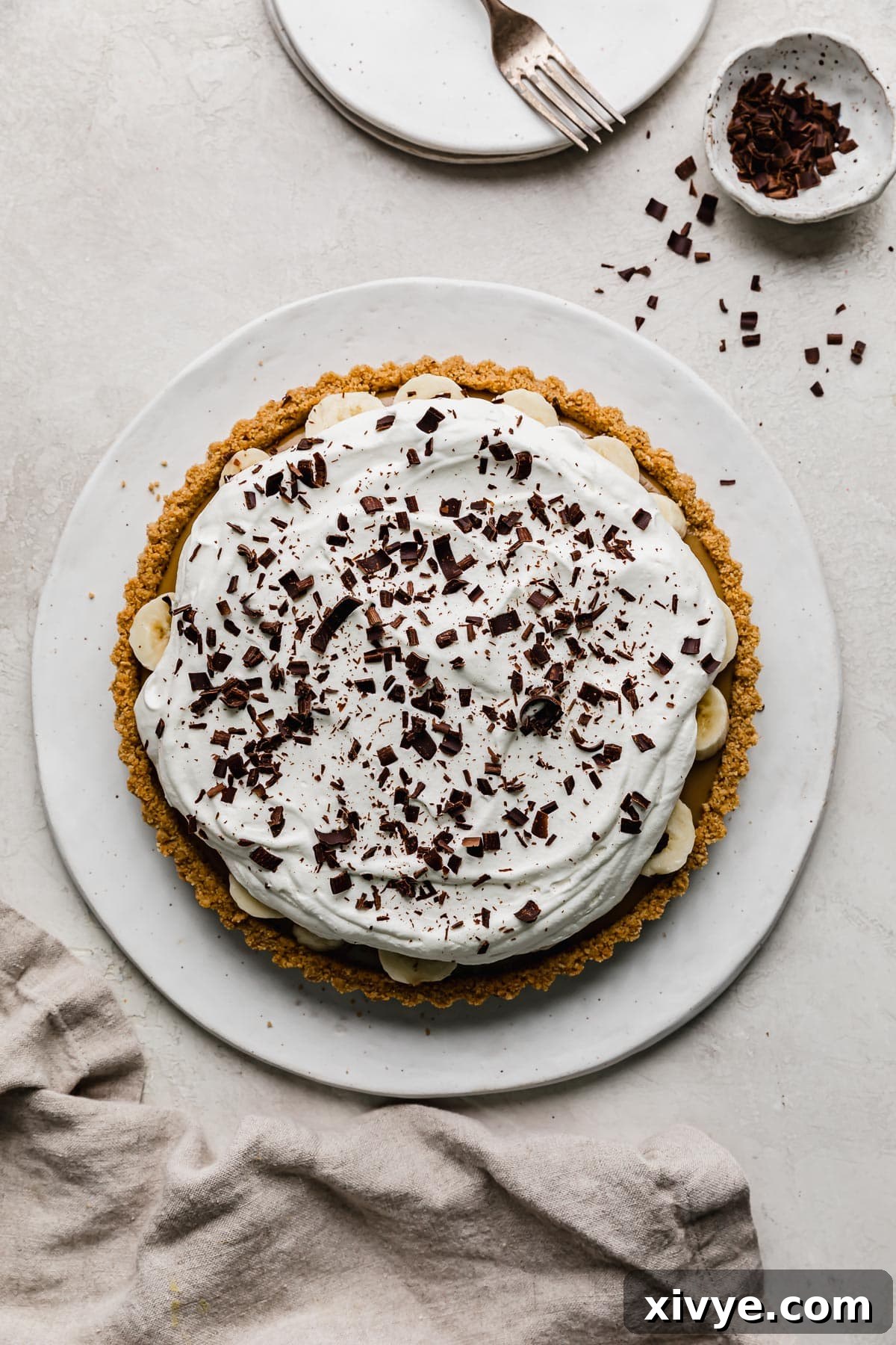 Decadent Banoffee Pie with Crunchy Graham Crust 11 A traditional English banoffee pie recipe with a graham cracker crust, filled with homemade dulce de leche, topped with sliced bananas, whipped cream, and chocolate shavings.