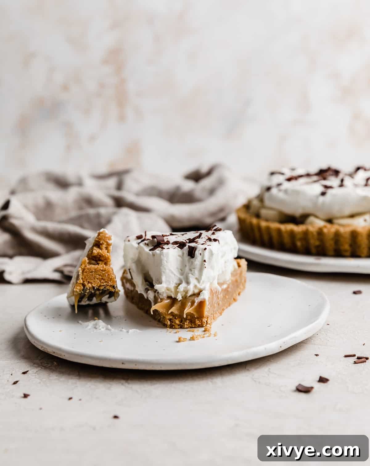 Decadent Banoffee Pie with Crunchy Graham Crust 13 A slice of Banoffee Pie on a white plate, showcasing the distinct layers.