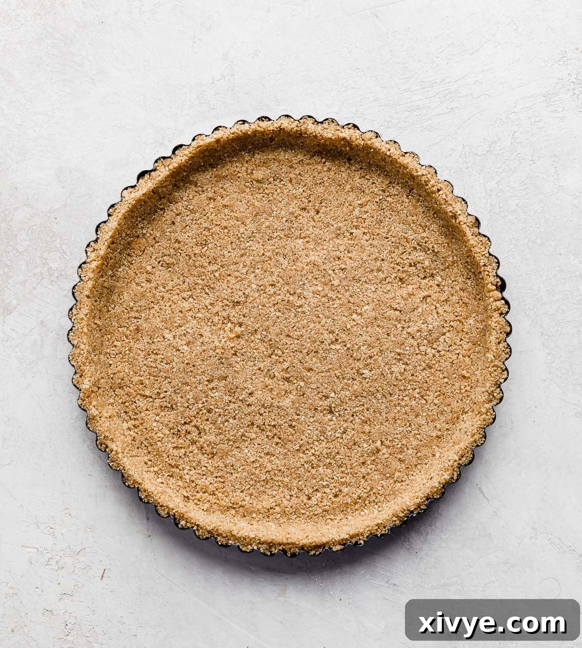 Decadent Banoffee Pie with Crunchy Graham Crust 4 A graham cracker crust in a circle tart pan.