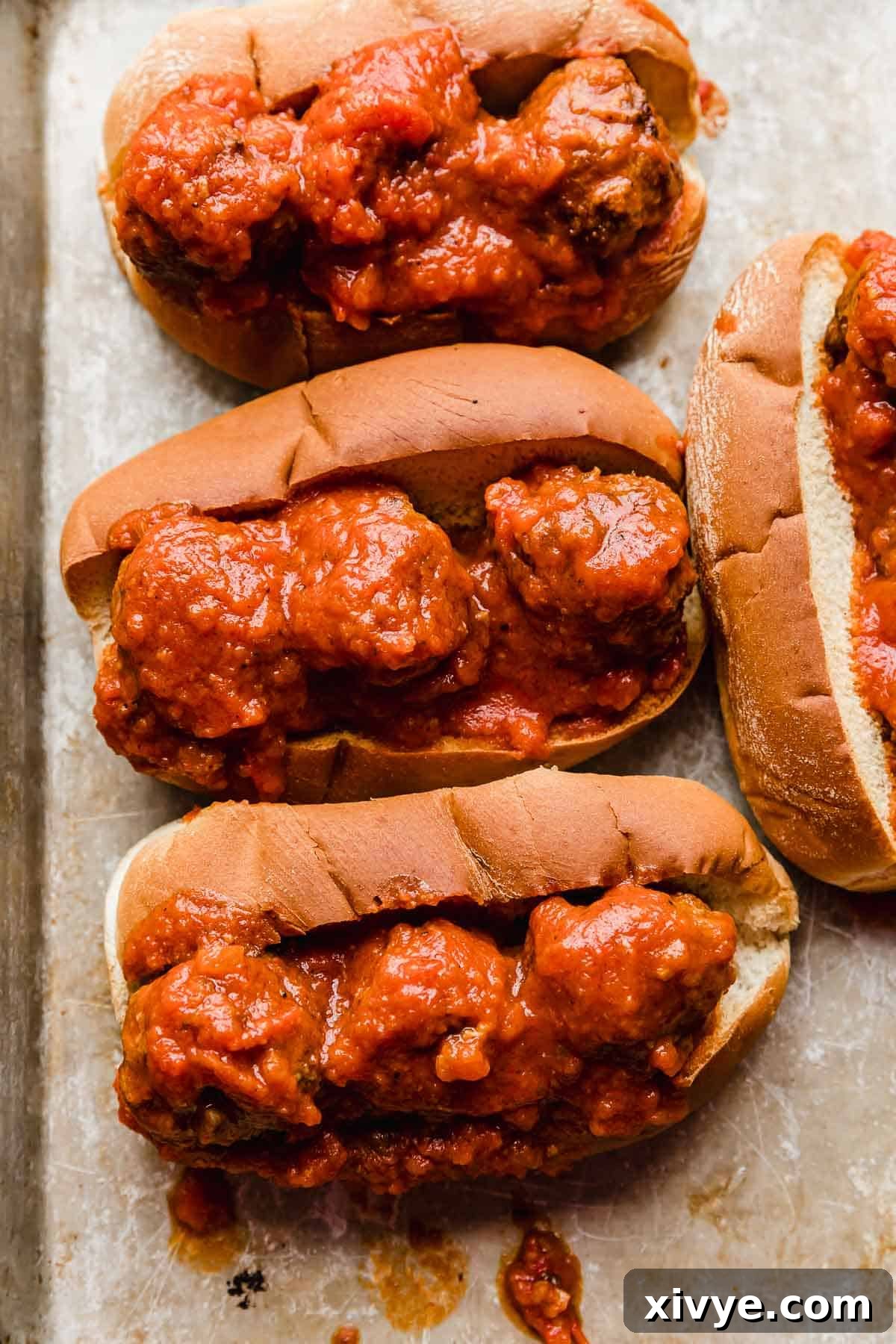 Saucy Italian Meatball Heroes 7 Marinara covered Italian meatballs on a bun.