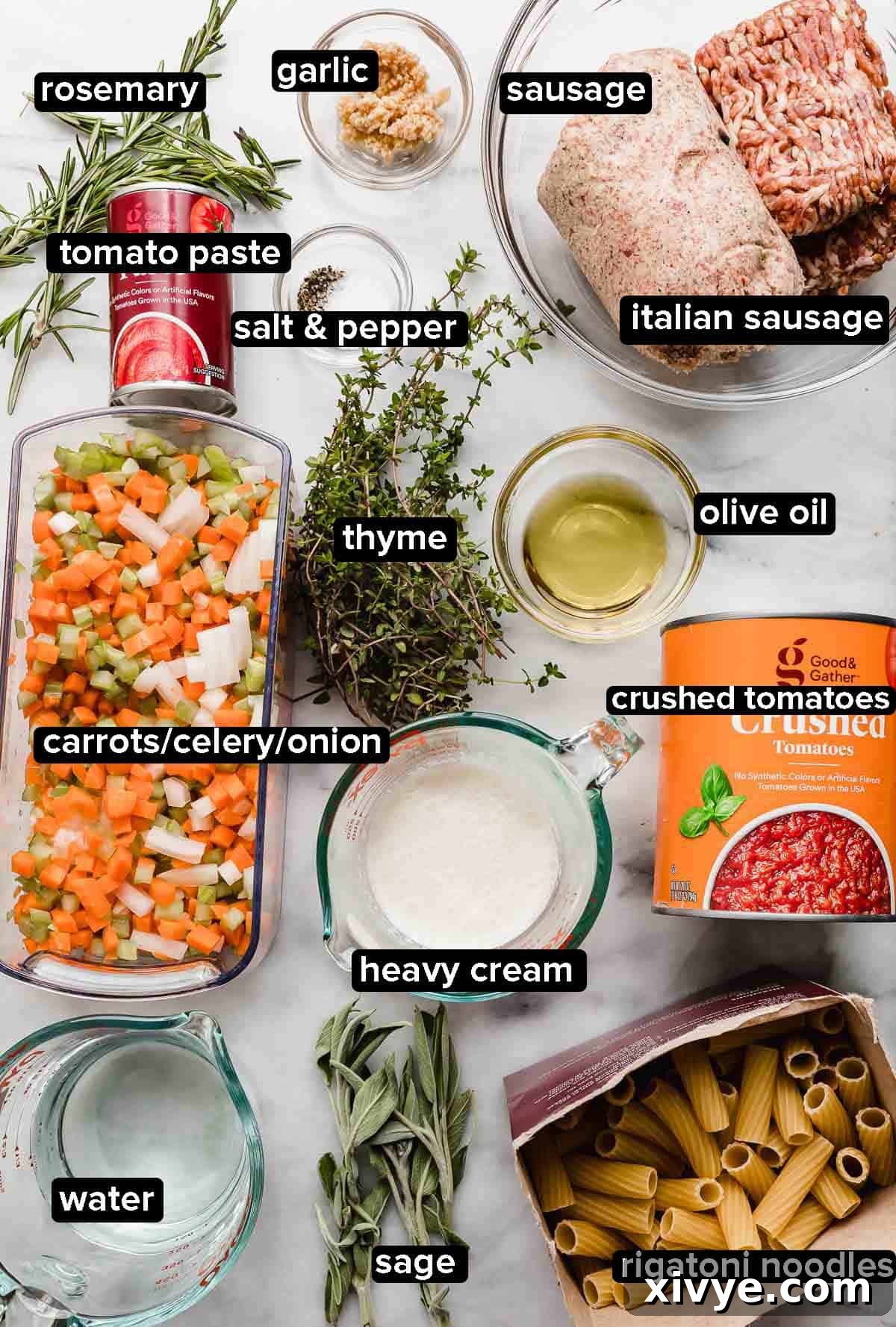 Rustic Sausage Ragu 3 Sausage Ragu ingredients on a white marble surface: fresh herbs such as sage, thyme, rosemary, crushed tomatoes, carrots, onion, celery, sausage and Italian sausage, rigatoni noodles, heavy cream, and tomato paste, all ready for cooking.