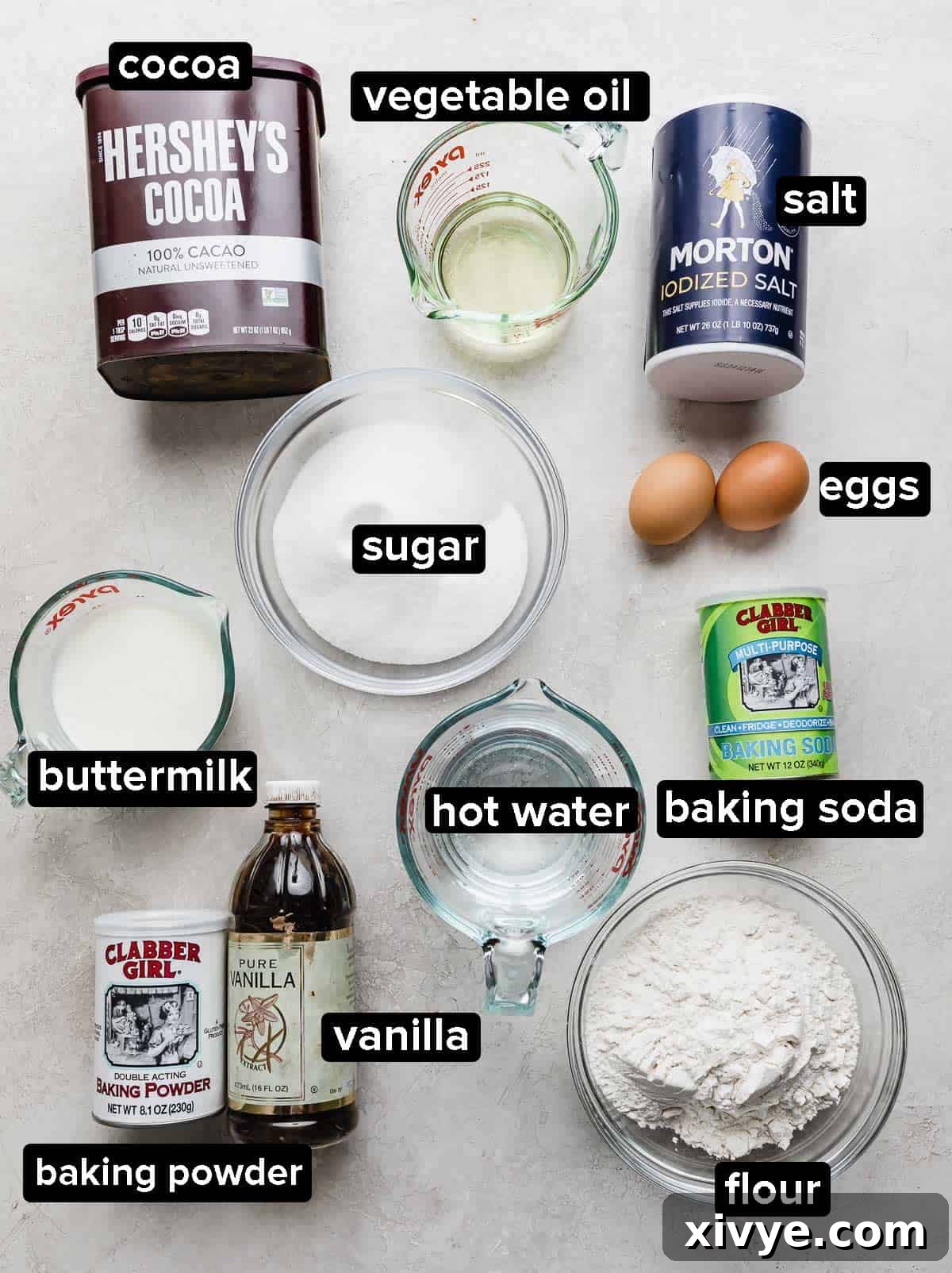 Chocolate Poke Cake ingredients portioned into glass bowls on a white background.