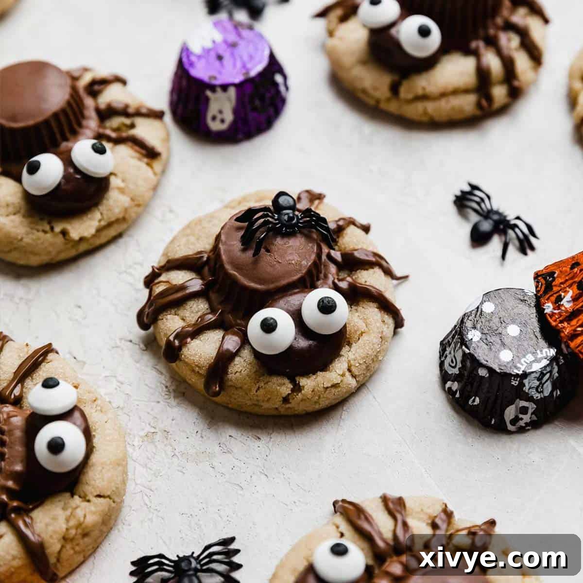A festive arrangement of Halloween Spider Cookies on a light gray surface, showcasing their adorable design and readiness for a party.