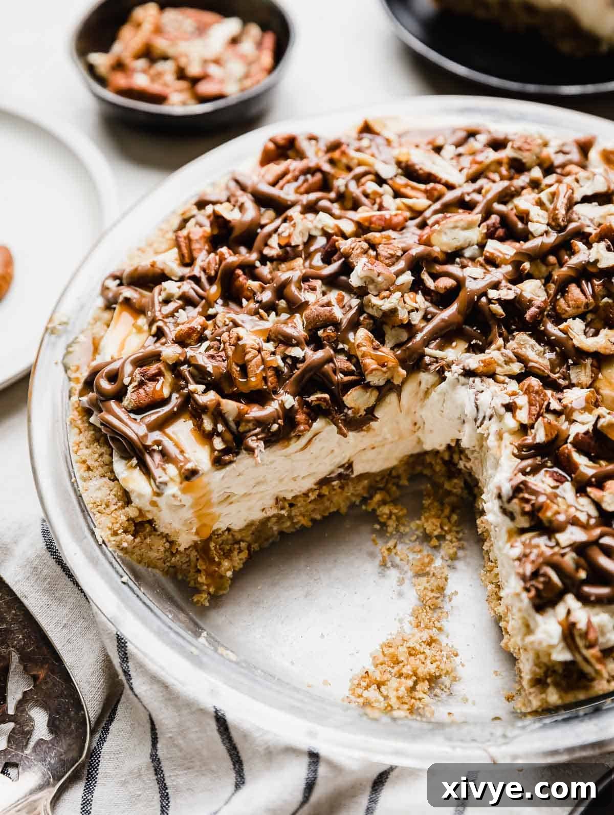Decadent Turtle Pie 2 A Turtle Pie recipe in a 9" pie plate with a pecan graham cracker crust, caramel cheesecake layer and chocolate caramel and pecan topping.