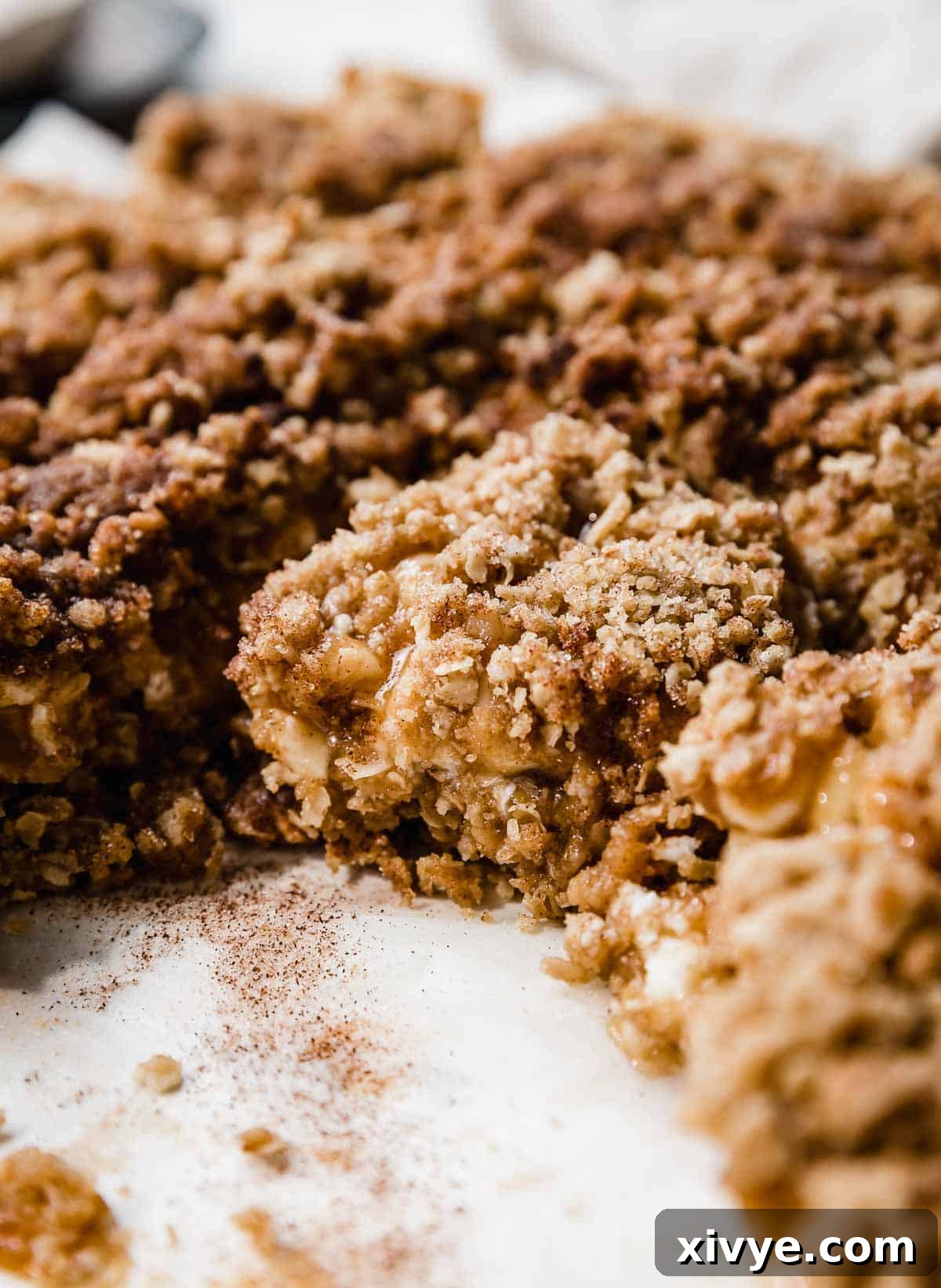 A square of snickerdoodle Carmelitas on a white parchment paper.