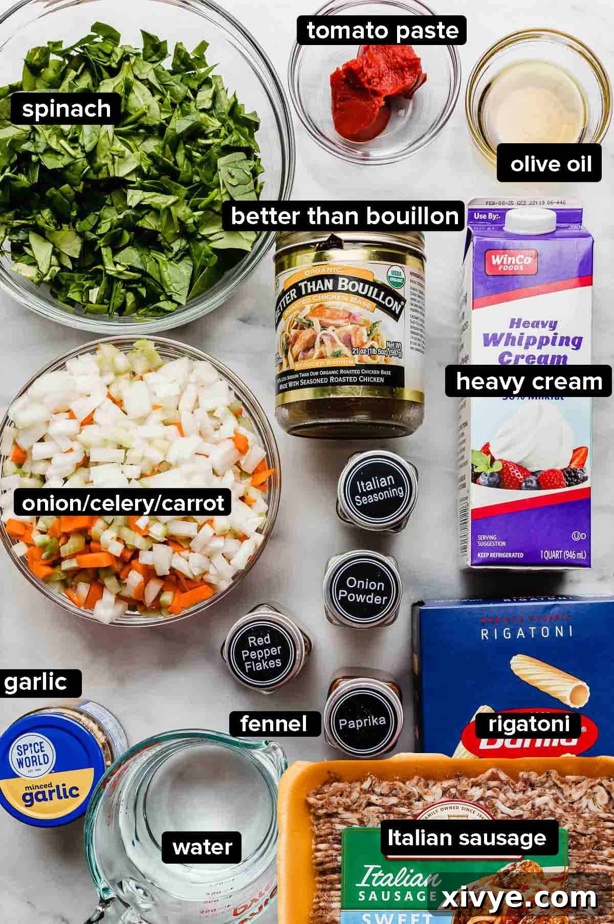 Hearty Italian Sausage Rigatoni 3 Italian Sausage Rigatoni ingredients on a white surface: pasta, Italian sausage, water, garlic, onions and carrots and celery, fennel, paprika, heavy cream, and chicken bouillon.