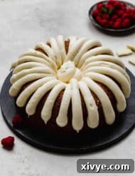 A Nothing Bundt Cake White Chocolate Raspberry Bundt Cake copycat recipe on a black plate on a light gray background.