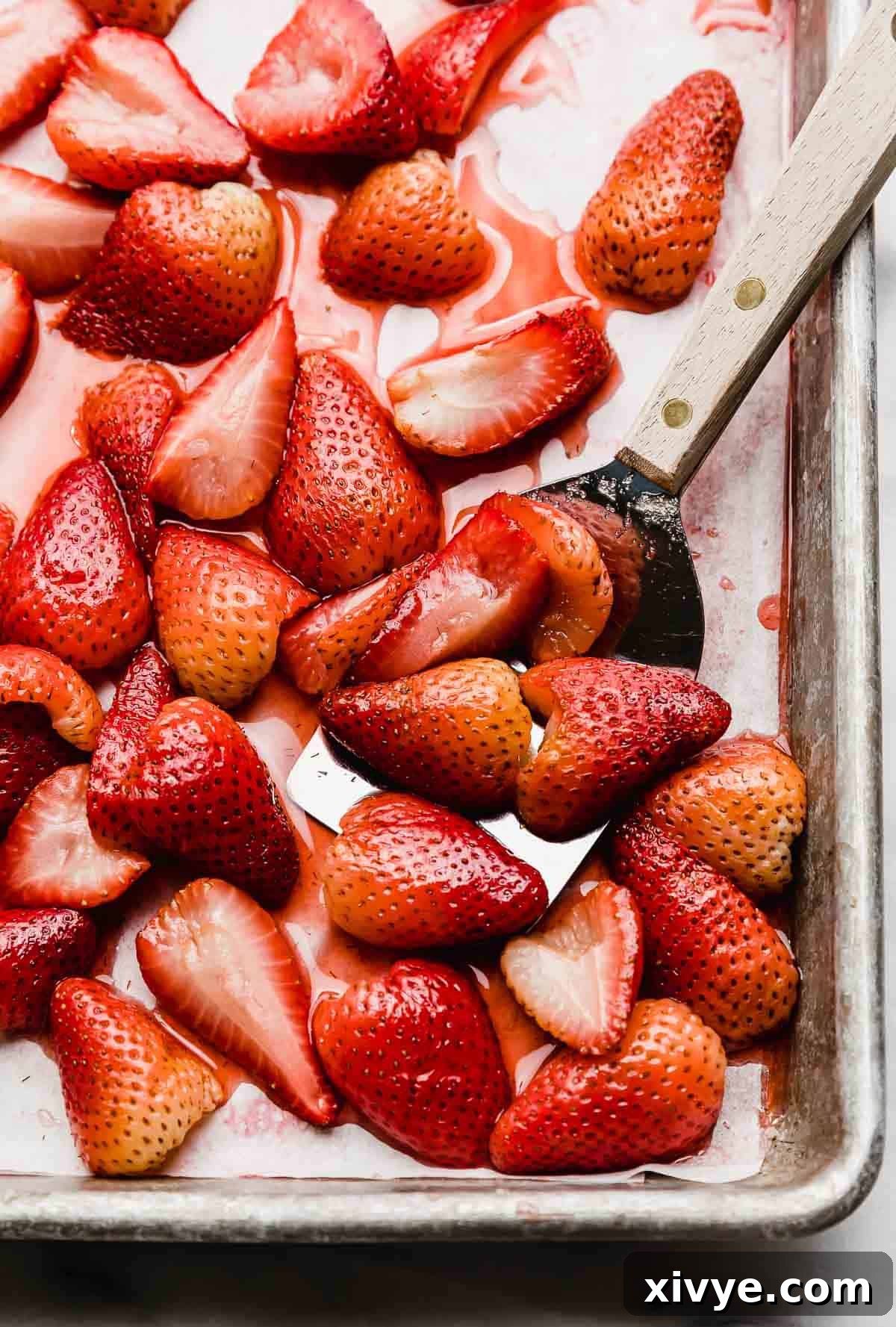 Easy Oven baked strawberry halves on a baking sheet.