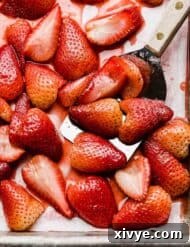 Baked strawberries recipe on a baking sheet.