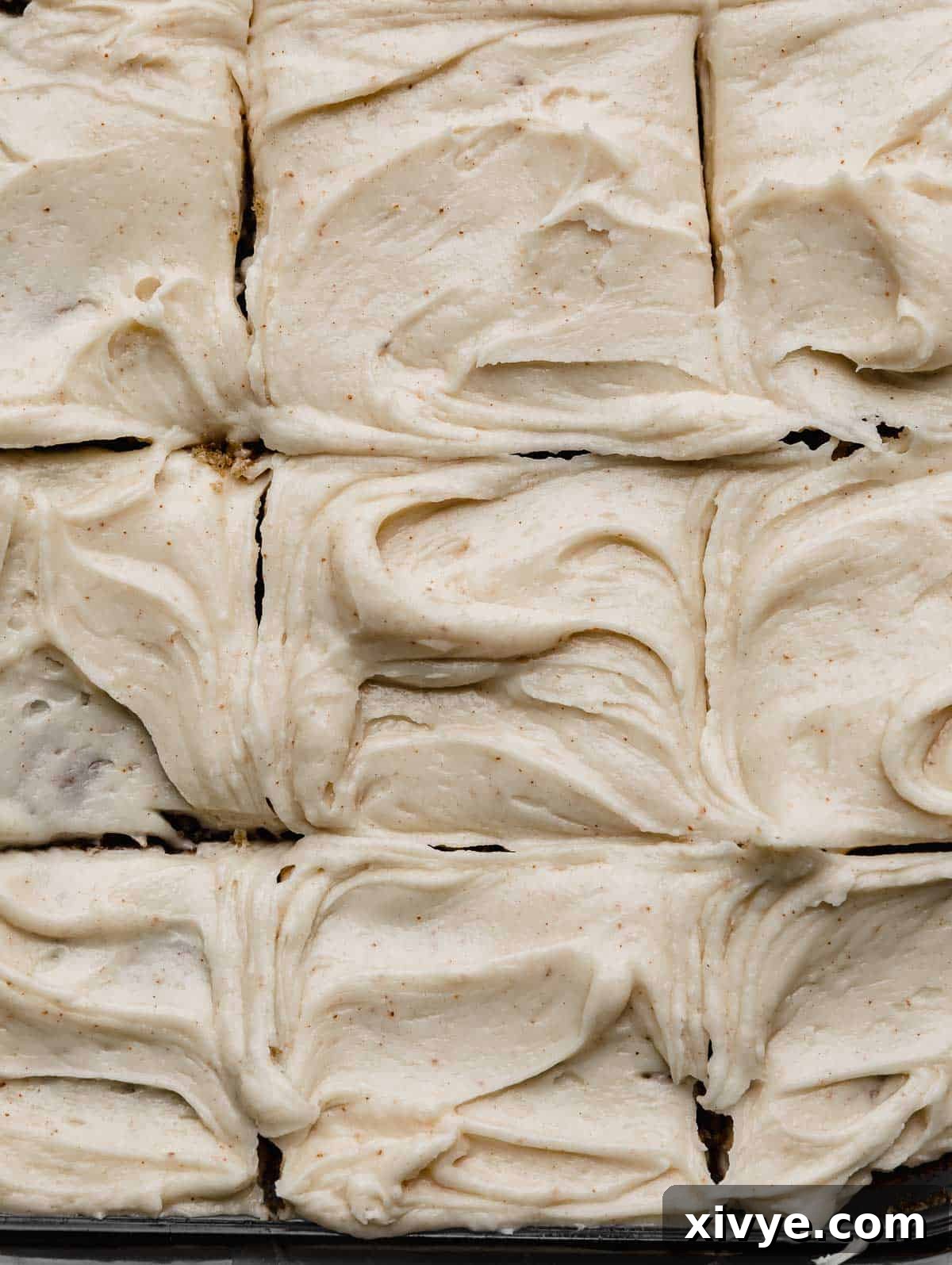 Swirled Brown Butter Cream Cheese Frosting with small brown specks throughout the frosting.