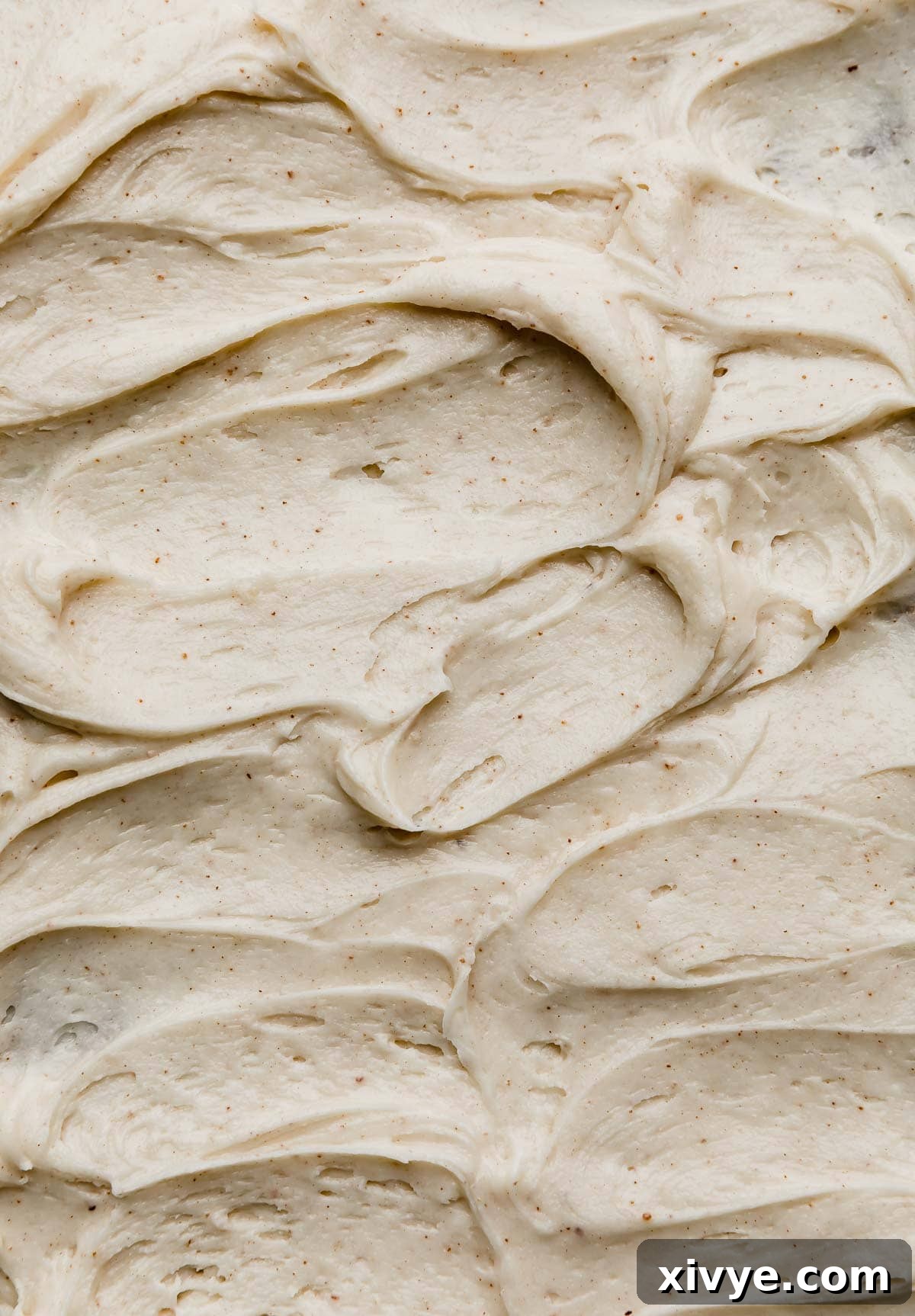 Swirled easy Brown Butter Cream Cheese Frosting recipe on a cake or other type of dessert.