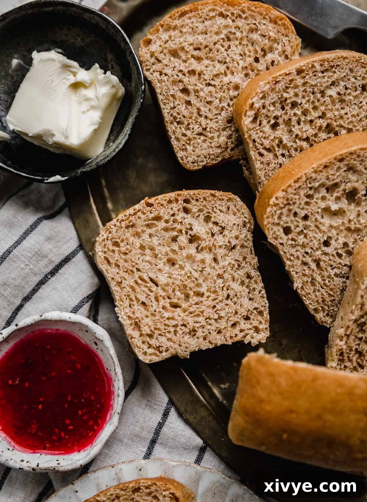 Fifty-Fifty White and Whole Wheat Bread 14 Whole wheat white bread (50/50 bread) baked in a mini loaf pan and sliced, resting on a gold tray.