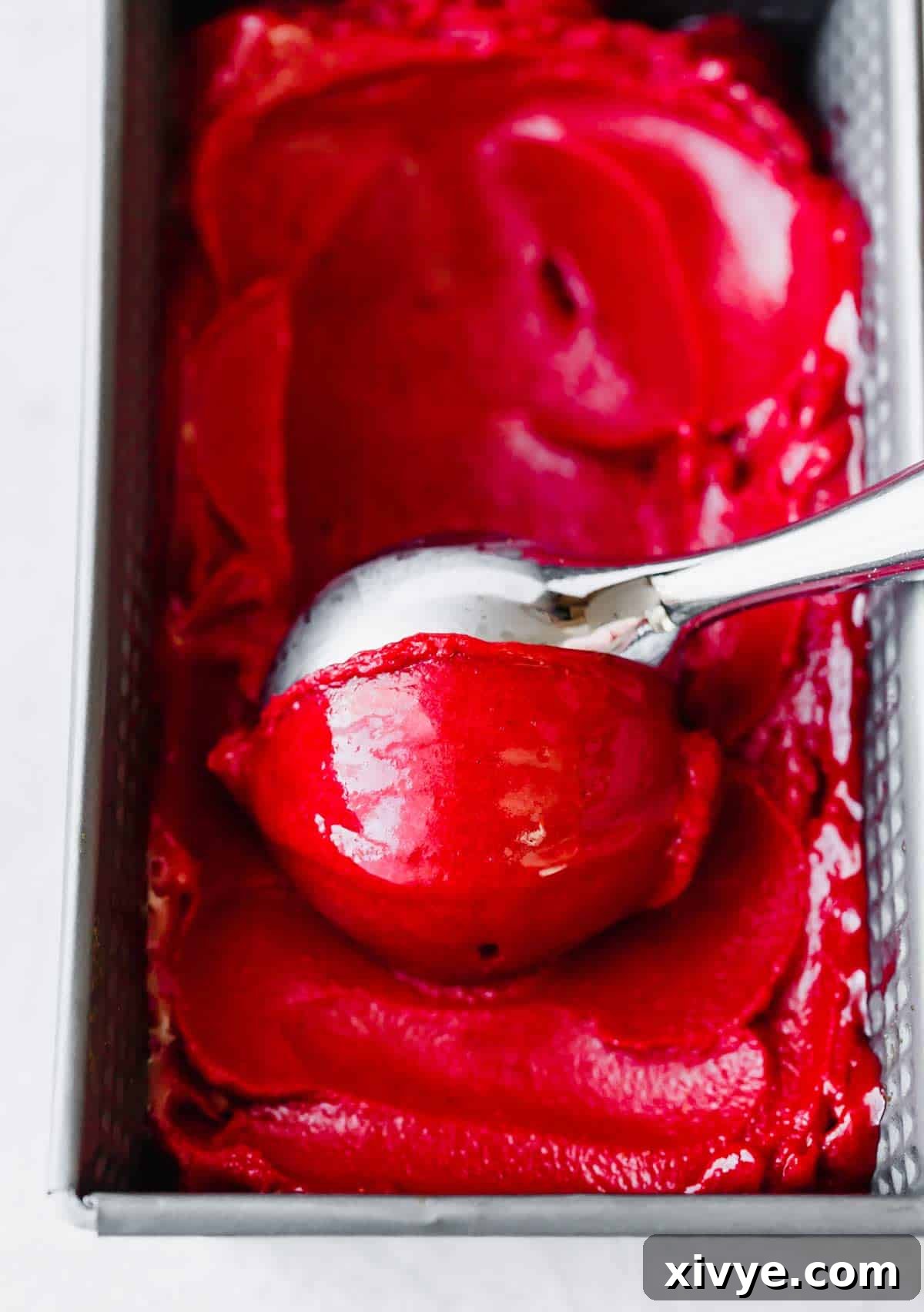 Crimson Raspberry Chill 6 An ice cream scooper scooping out Raspberry Sorbet.