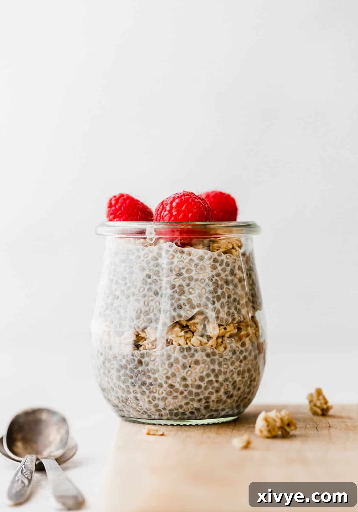 Overnight Oat Milk Chia Pudding 6 Chia pudding in a glass jar topped with fresh raspberries.