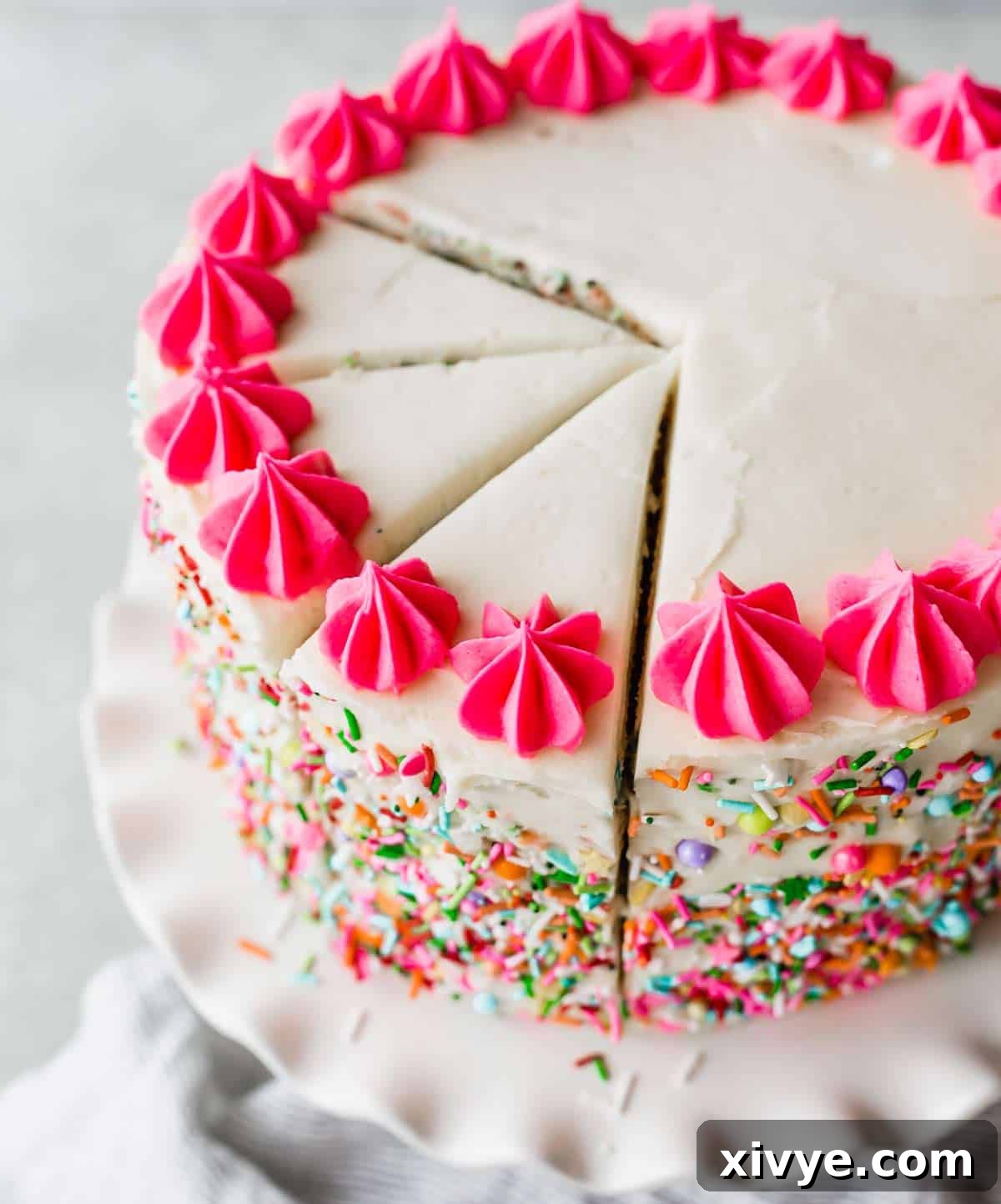 A freshly frosted Funfetti cake, ready for final decoration, showcasing its vibrant layers.