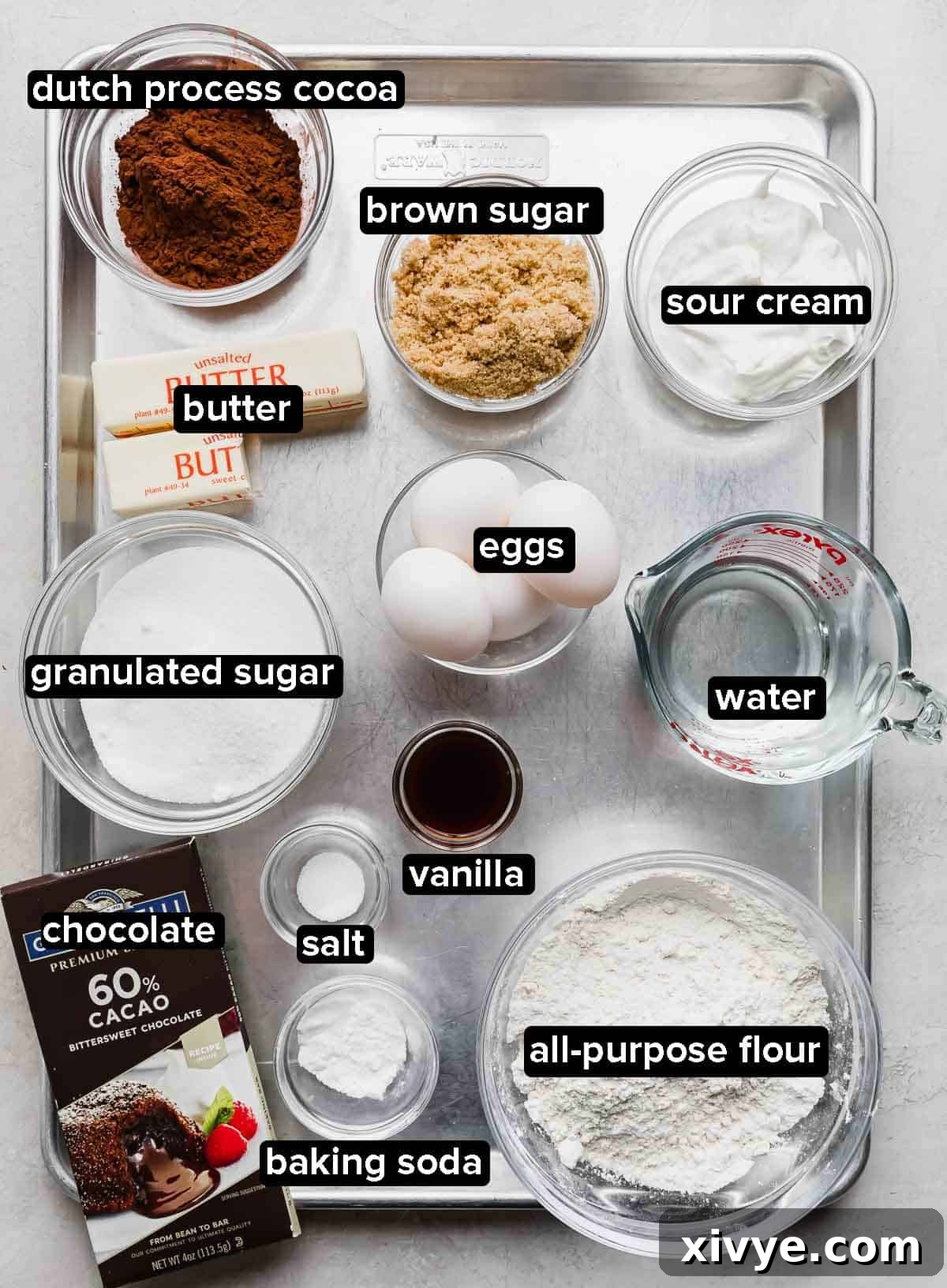 Traditional German Chocolate Cake ingredients portioned into glass bowls on a silver baking sheet.