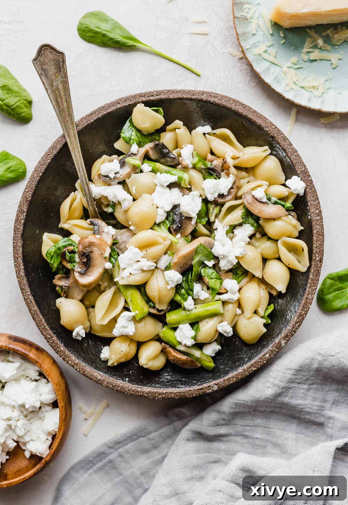 Fresh Asparagus Spinach Pasta in a black pasta bowl on a white background.