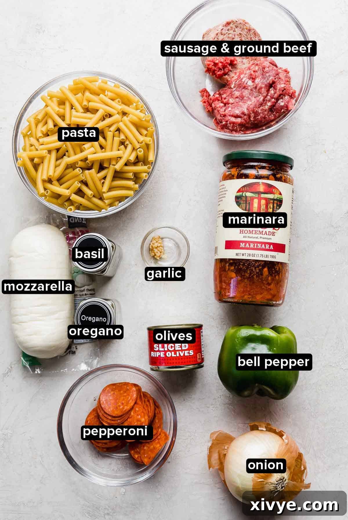 Pizza casserole ingredients on a light gray background. 