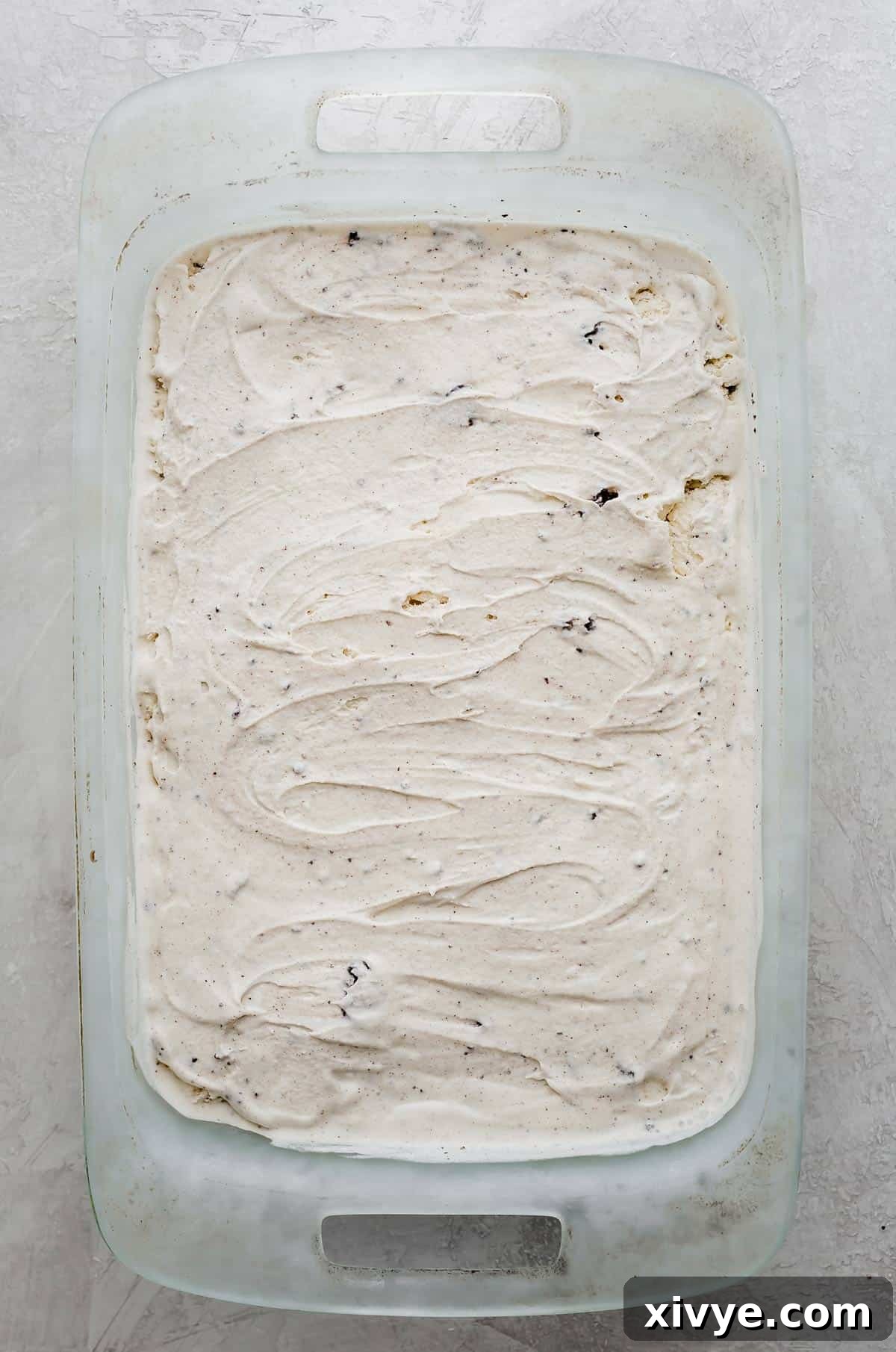 Dreamy Oreo Ice Cream Cake 5 Cookies and cream ice cream flattened into a rectangular baking dish, creating the second layer of the cake.