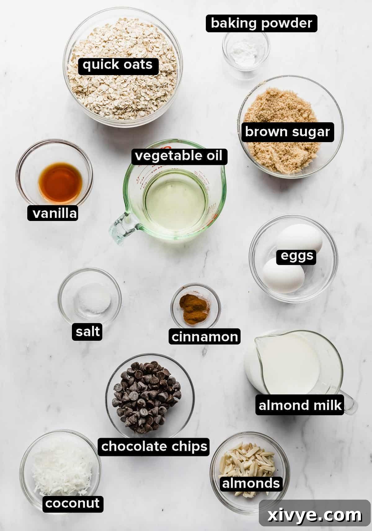 Ingredients used to make Baked Oatmeal Cups in glass bowls on a white background. 