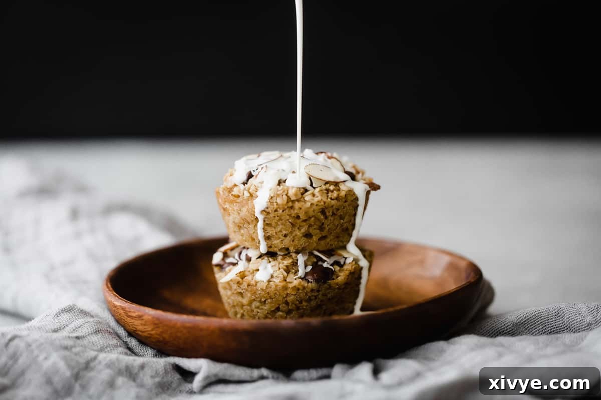 Milk being poured over top Baked Oatmeal Cups on a brown plate.