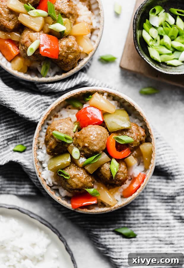 Delectable Sweet and Sour Slow Cooker Meatballs 2 A bowl of Slow Cooker Sweet and Sour Meatballs Recipe topped with chopped green onions, ready to be served.
