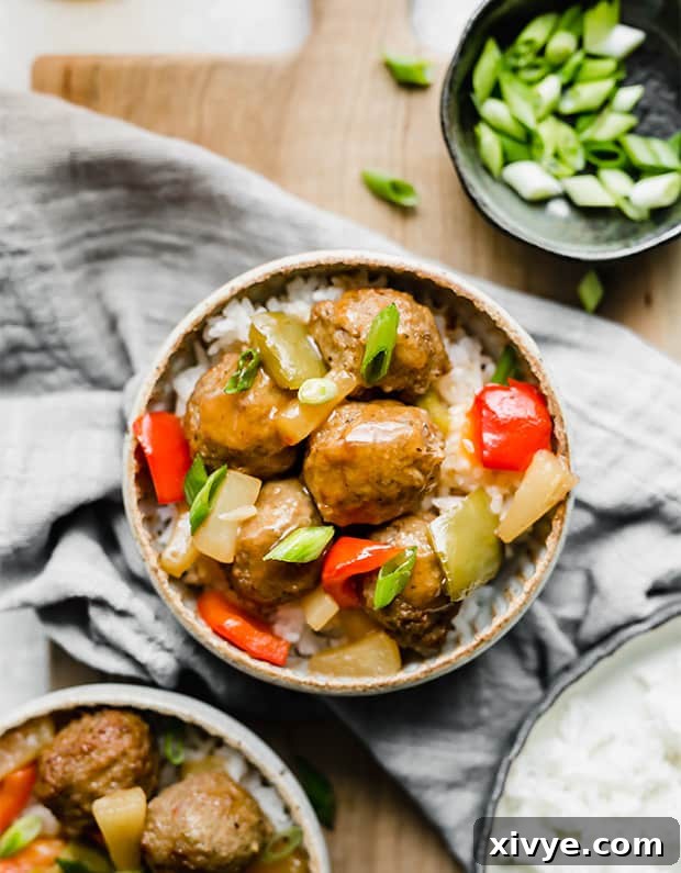 Delectable Sweet and Sour Slow Cooker Meatballs 8 A beautifully presented bowl of sweet and sour meatballs topped with fresh green onions, showcasing the rich sauce and tender meatballs.
